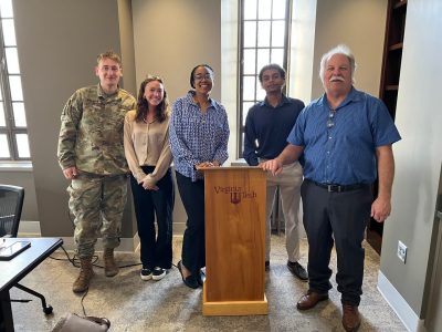 The team poses together after William Layton’s presentation. Pictured left to right: Alex Brandon, Lauren Armstrong, Anarra Williams, Christian Seeney, and William Layton